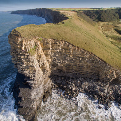 A view from the air of Nash Point and the beach and ocean at low tide near to Wagon House Holiday Cottages. Wagon House Holiday Cottages are in the beautiful Vale of Glamorgan, Wales. The converted holiday cottages are situated in a quiet village only 10 minutes walk from the sea.