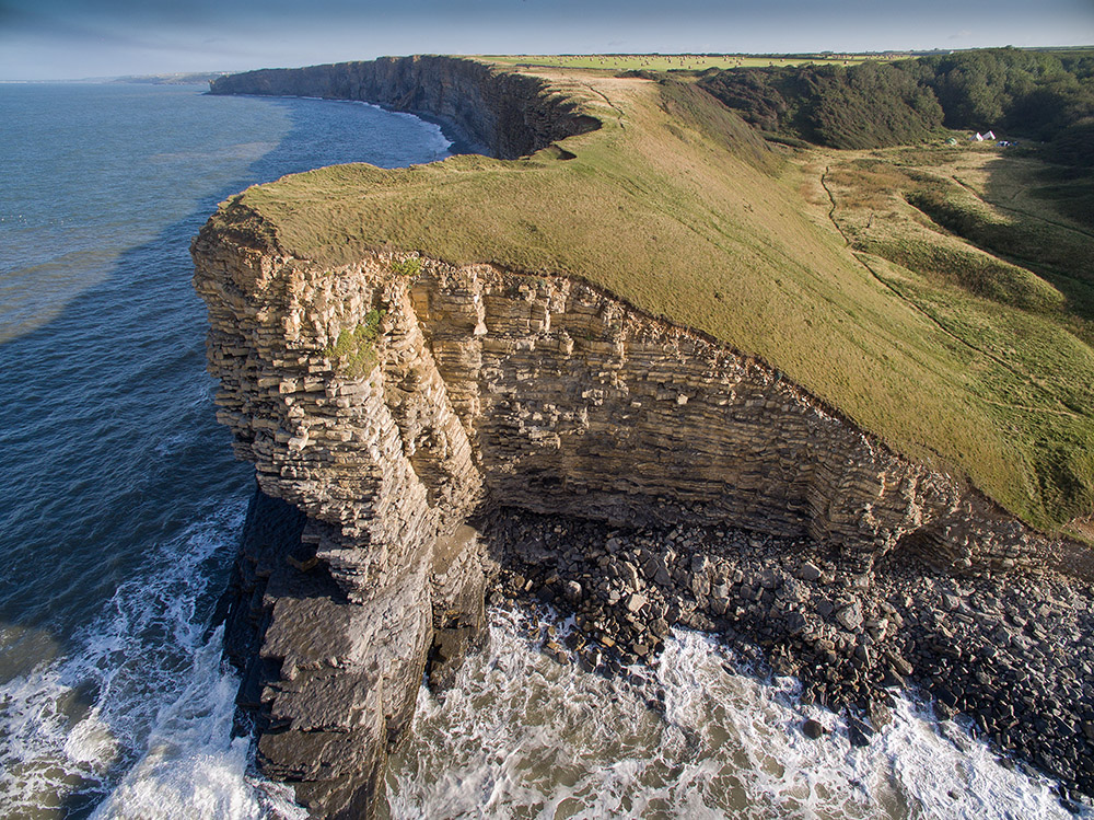 A view from the air of Nash Point and the beach and ocean at low tide near to Wagon House Holiday Cottages. Wagon House Holiday Cottages are in the beautiful Vale of Glamorgan, Wales. The converted holiday cottages are situated in a quiet village only 10 minutes walk from the sea.