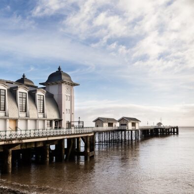 A beautiful view of Penarth Pier and the beach and ocean at high tide near to Wagon House Holiday Cottages as the sun goes down. Wagon House Holiday Cottages are in the beautiful Vale of Glamorgan, Wales. The converted holiday cottages are situated in a quiet village only 10 minutes walk from the sea.